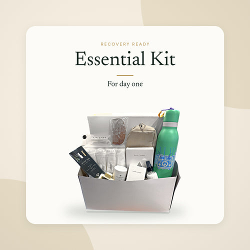 Recovery Ready Essential Kit packed in its gift box: toiletries, washcloths, comb, lip balm, toiletry bag and water bottle